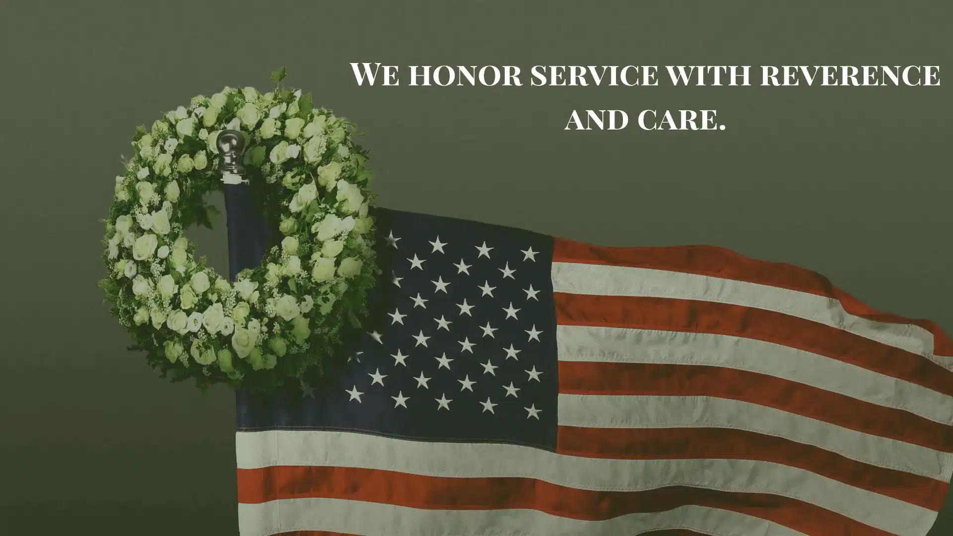 American flag with a floral wreath draped over it, symbolizing honor and remembrance.