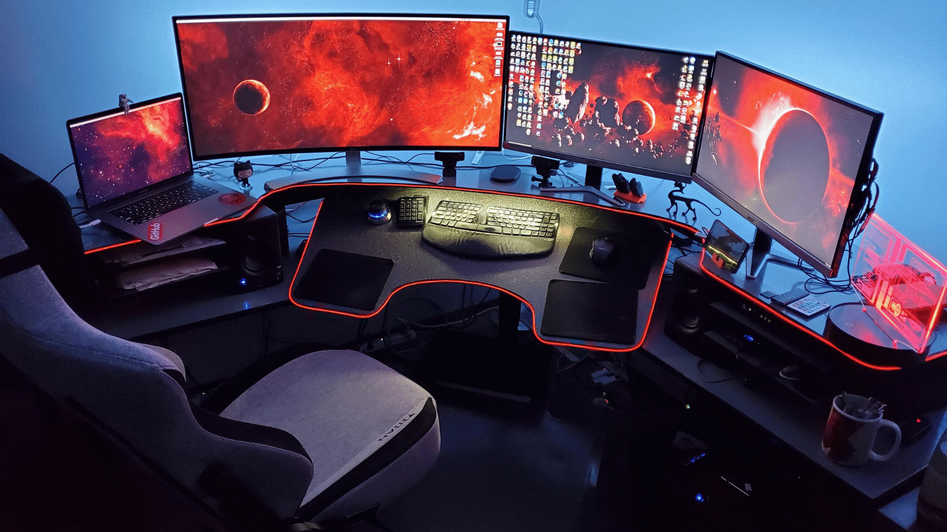 Four monitor gaming setup with red color theme