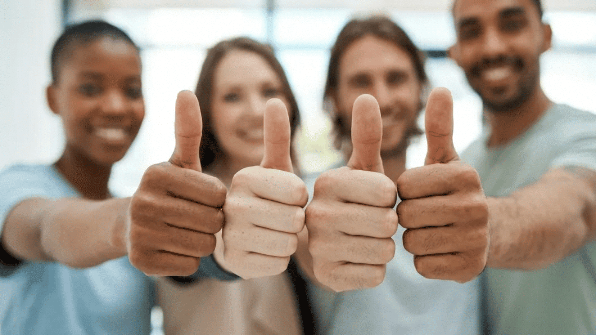Team members giving thumbs up for positive performance review examples.