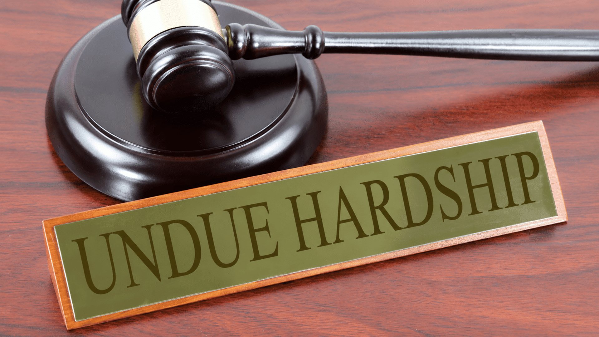 Gavel next to a nameplate reading undue hardship representing employment law ruling