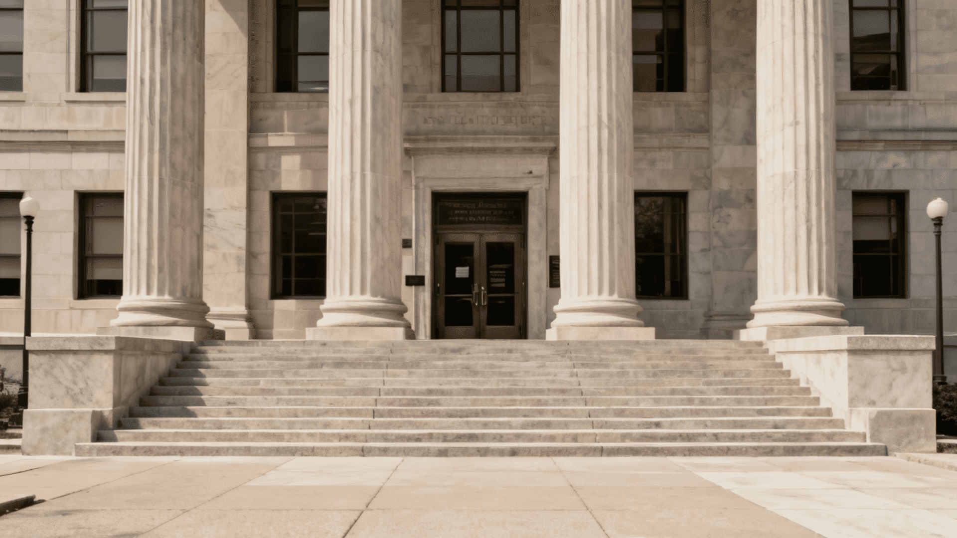 Courthouse building entrance with large columns and wide stone steps.