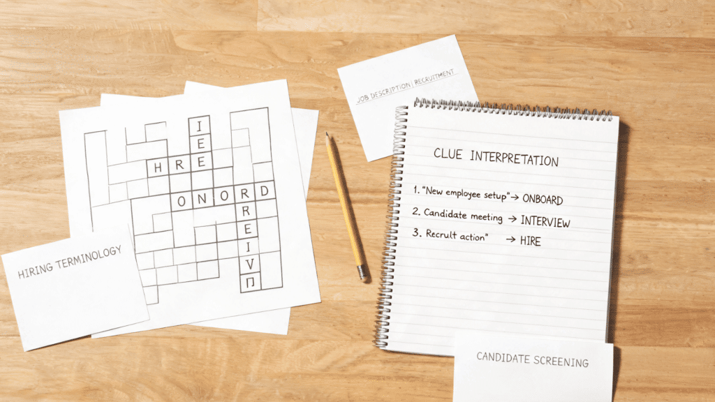 Hiring terminology crossword puzzle with recruitment notes, notebook, pencil, and job-related clues on a desk.