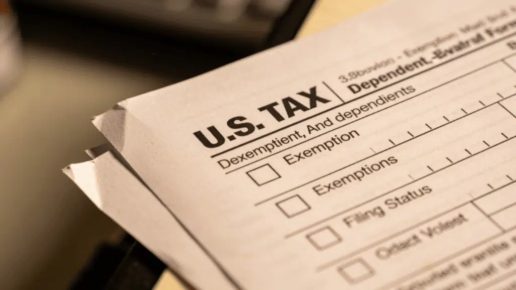 Close-up of tax form section showing exemption checkboxes and filing status fields on a printed document.