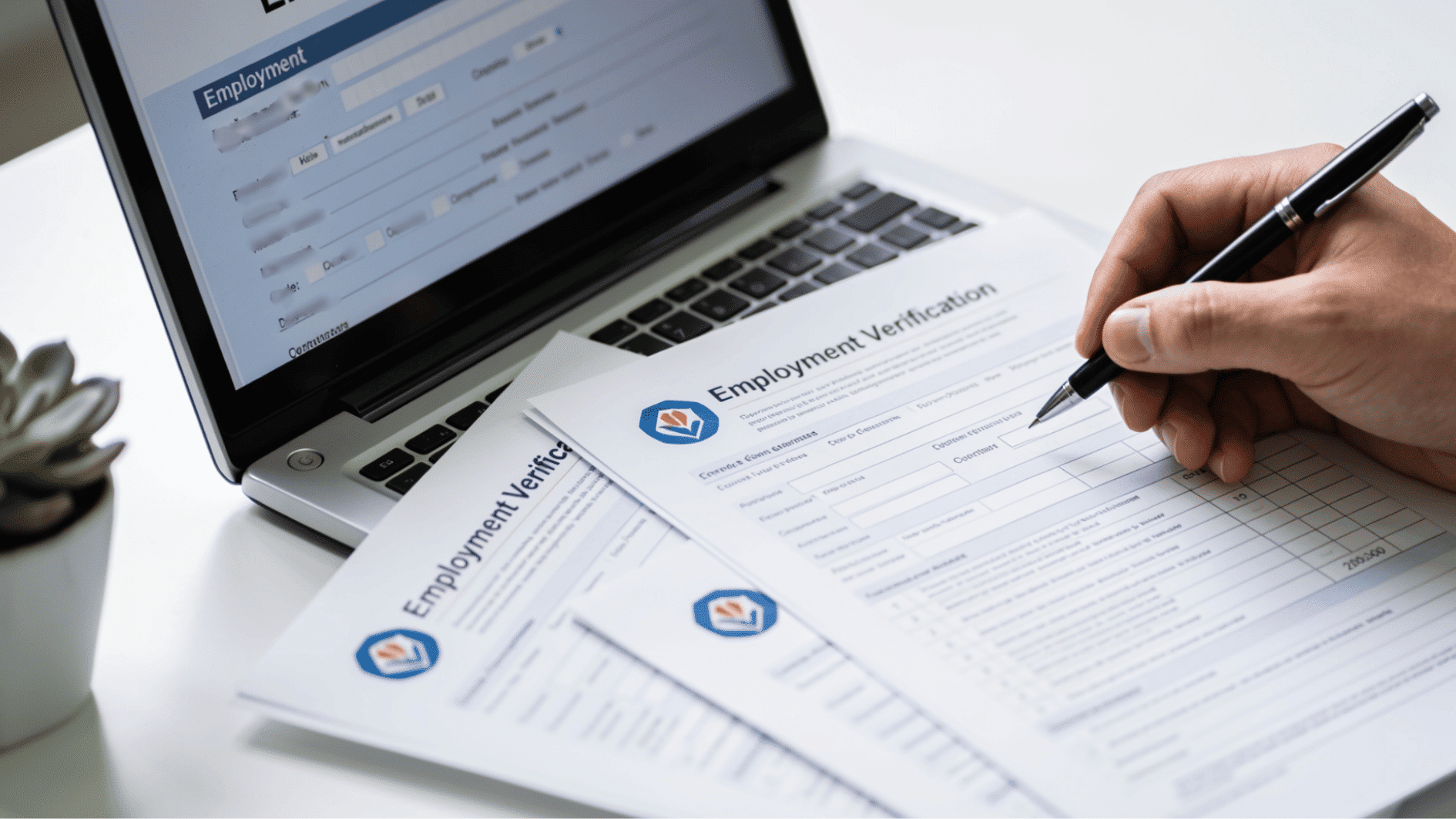 Documents and laptop used for verifying employment or education information on a desk