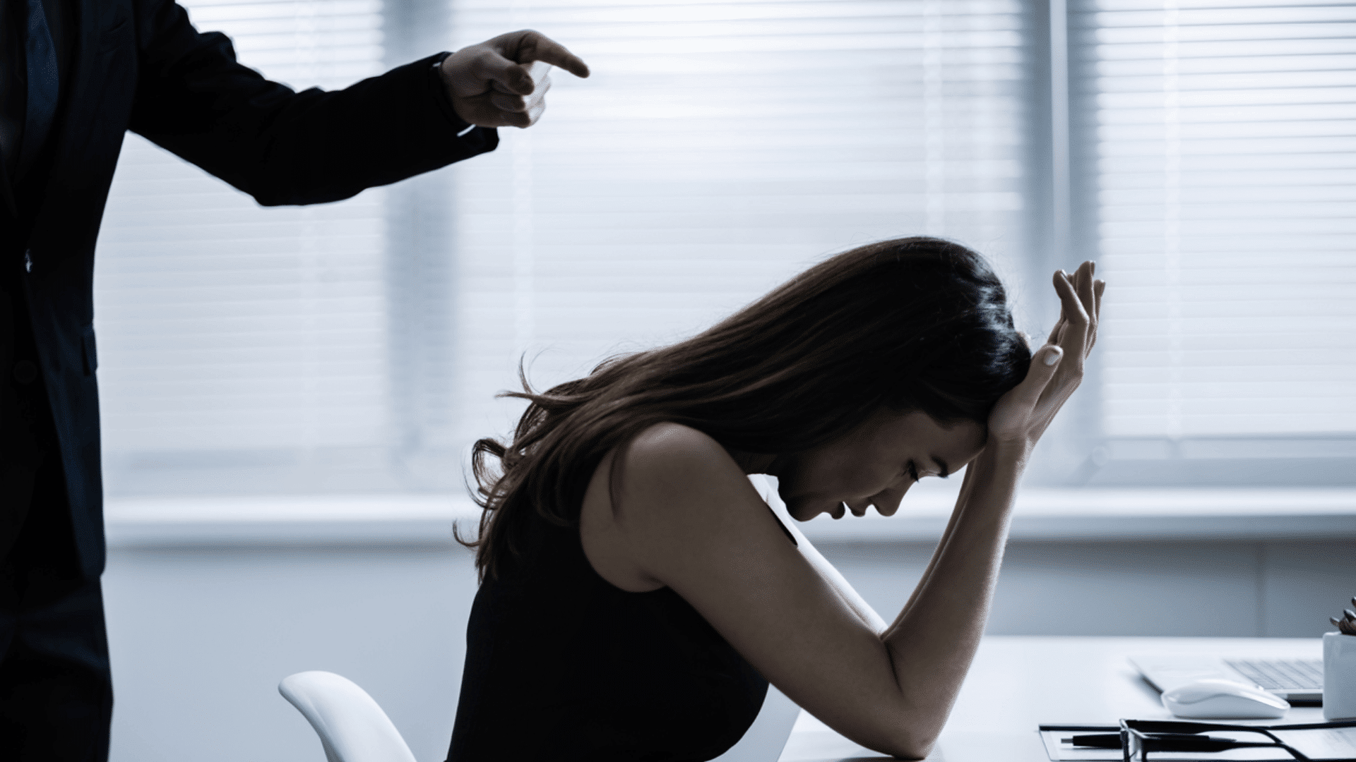 10:49 AMClaude responded: person pointing aggressively at a distressed woman with her head down at a deskperson pointing aggressively at a distressed woman with her head down at a desk