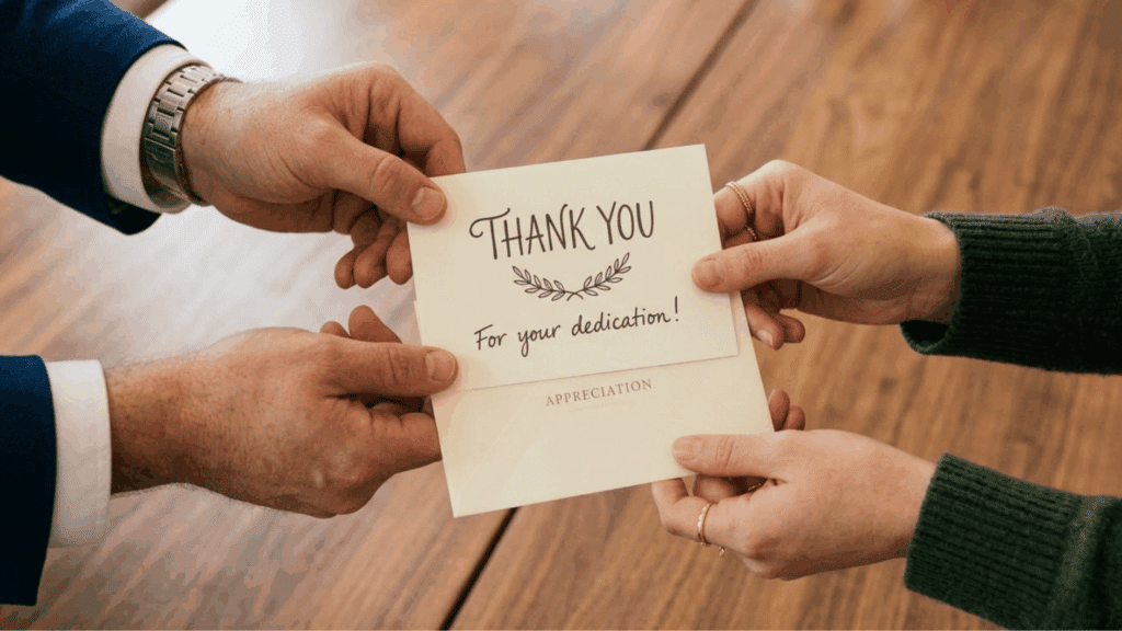 an employer giving appreciation card to the employees on employee appreciation day